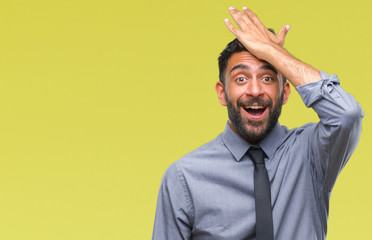 Adult hispanic business man over isolated background surprised with hand on head for mistake,...