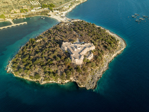 Aerial view of Porto Palermo Castle on island with beautiful Mediterranean waters in Himara, Albania 