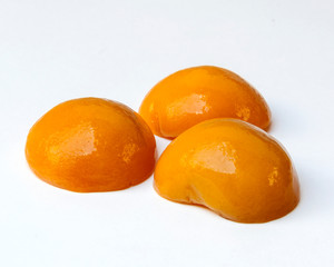 Peach in syrup surrounded by white background