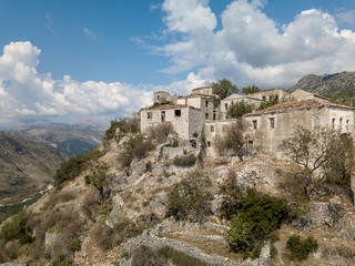 Photo of abandoned Albanian buildings in the village of Upper Qeparo, Albania