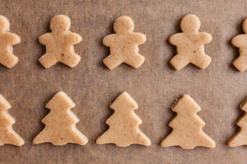 Homemade Christmas gingerbread. Raw dough. Bells, little men, horses, Christmas trees. Winter background