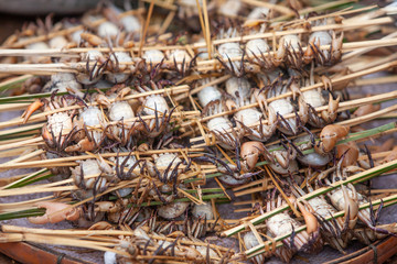 Wild crab with sticks in a wet market in Laos.