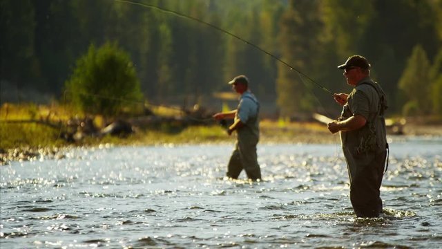 Canadian males fly fishing in competition on freshwater river