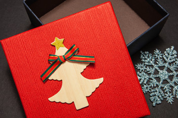 Gift box in red with a snowflake for a gift for a new year or birthday. Close-up