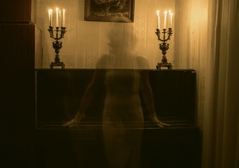 Ghost woman in room with candles