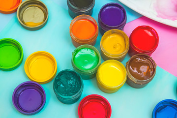 in jars of multi-colored paint for drawing