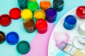 in jars of multi-colored paint for drawing