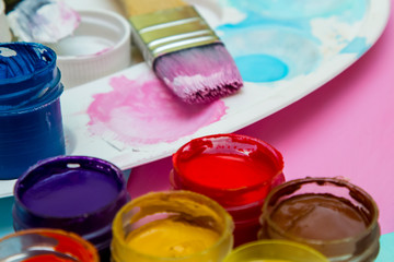 in jars of multi-colored paint for drawing