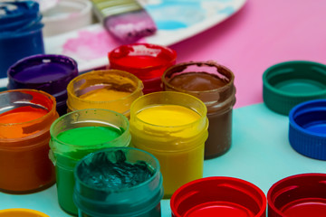 in jars of multi-colored paint for drawing