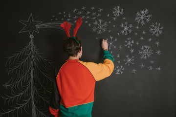 young drawing and decorating christmas
