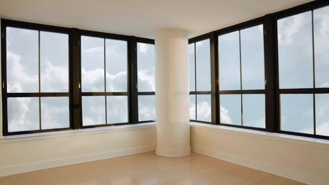 Panoramic view from skyscraper window in empty room on clouds in sky