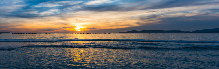 Obraz premium Panoramic view of Alghero shore at sunset