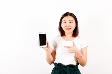 Fototapeta premium Portrait of beautiful asian young woman with brunette hair and bob hairstyle, fashionable hipster outfit alone in bright lighted room. Background, copy space for text, close up.