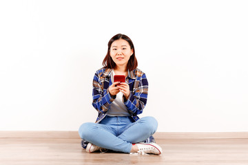 Portrait of beautiful asian young woman with brunette hair and bob hairstyle, fashionable hipster outfit alone in bright lighted room. Background, copy space for text, close up.