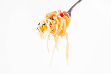 Spaghetti Carbonara with some parsley on a fork on a white background