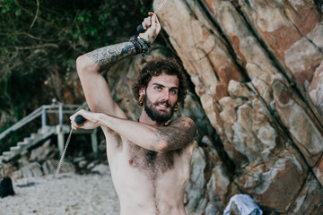 Handsome guy training on the beach