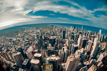 Fisheye aerial view looking down at the sprawling metropolis of Chicago Illinois with Lake Michigan...