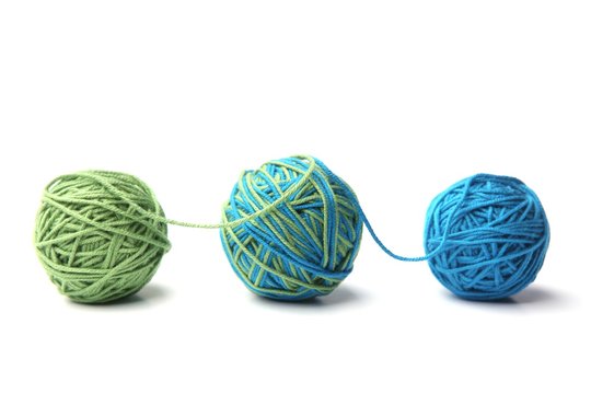 Colorful cotton thread ball from two color green and blue thread isolated on white background. Different color green and blue thread mix.