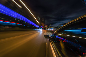 View from Side of Car moving in a night city