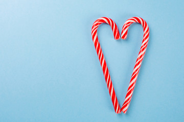 lollipops in the shape of a heart on blue background