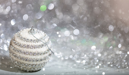 Christmas ball and snow, abstract bokeh lights background
