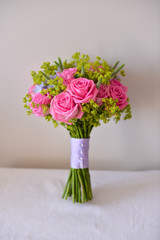 bridal bouquet of fresh roses on the table. wedding floristry, floristic decorative statement