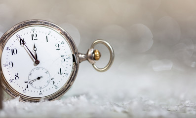 Fototapeta na wymiar New Years eve. Minutes to midnight on an old fashioned pocket watch