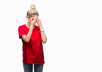 Young beautiful blonde woman wearing red t-shirt and glasses over isolated background with sad expression covering face with hands while crying. Depression concept.