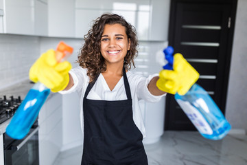 Young latin Woman cleaning kitchen. Young woman washing kitchen hood