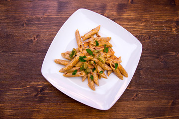Pasta with asparagus and cream on a wooden table top view