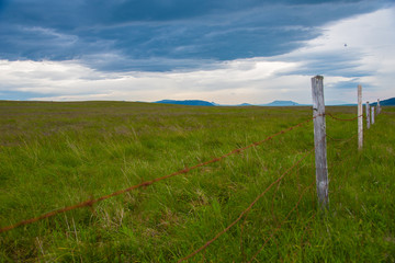Peaceful landscape in Iceland with barbed wire fence in foreground
