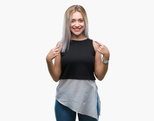 Young blonde woman over isolated background looking confident with smile on face, pointing oneself with fingers proud and happy.