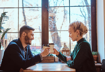 Romantic couple in the cafe is drinking coffee and talking. 