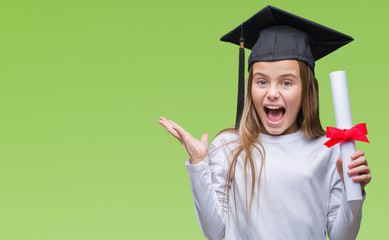 Young beautiful girl wearing graduate cap holding degree over isolated background very happy and...
