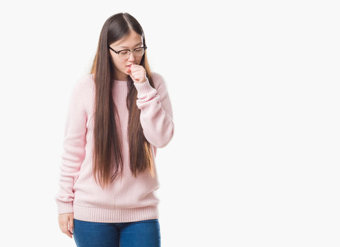 Young Chinese woman over isolated background wearing glasses feeling unwell and coughing as symptom for cold or bronchitis. Healthcare concept.