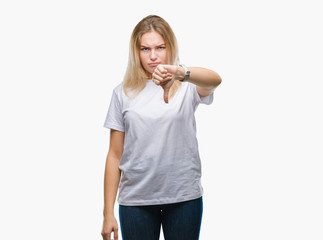 Young caucasian woman over isolated background looking unhappy and angry showing rejection and negative with thumbs down gesture. Bad expression.