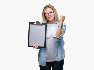 Young caucasian business woman holding clipboard over isolated background annoyed and frustrated shouting with anger, crazy and yelling with raised hand, anger concept