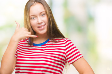 Young caucasian beautiful woman over isolated background smiling doing phone gesture with hand and fingers like talking on the telephone. Communicating concepts.