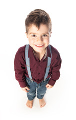 A four year old boy posing over white studio background