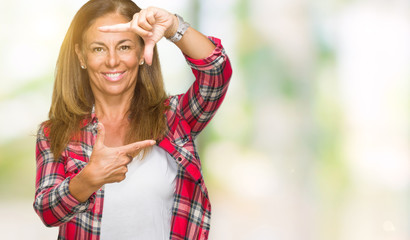 Middle age adult woman wearing casual shirt over isolated background smiling making frame with hands and fingers with happy face. Creativity and photography concept.