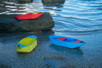 Colorful Paper Boats and reflection on the water