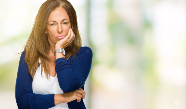 Beautiful middle age casual adult woman over isolated background thinking looking tired and bored with depression problems with crossed arms.