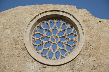 Rose window of Church San Giovanni and Catacombs in Syracuse, Sicily Italy