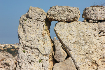 View of big church dome through hole in giant ancient stones Ggantija Temples