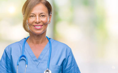 Middle age senior nurse doctor woman over isolated background with a happy and cool smile on face....