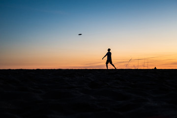 Frisbee player at sunset