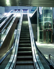 escalator at the exit from the train station and crystal lift for the disabled,Milan. Italy