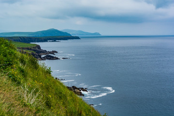 Obraz premium The world famous Ring of Kerry is a 'must do' scenic tourist drive or cycle in County Kerry, in the south west of Ireland. Very foggy but still beutiful. Wild Atlantic Way