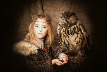 Girl in the style of boho with an owl. Boho chic hugs big owl