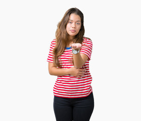 Young beautiful brunette woman wearing stripes t-shirt over isolated background looking at the camera blowing a kiss with hand on air being lovely and sexy. Love expression.
